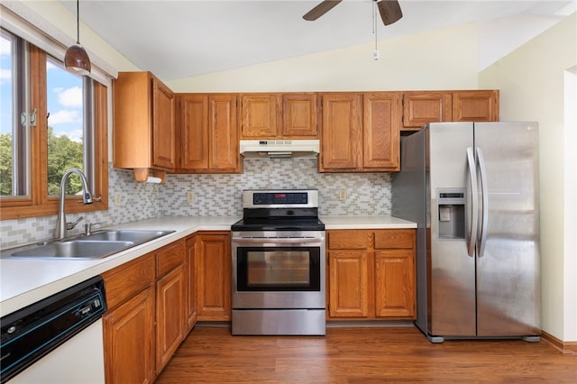 29 Teakwood Dr W, Coventry, RI 02816 - kitchen featuring appliances with stainless steel finishes, under cabinet range hood, vaulted ceiling, light countertops, and backsplash