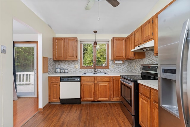 29 Teakwood Dr W, Coventry, RI 02816 - kitchen with appliances with stainless steel finishes, under cabinet range hood, dark wood-type flooring, light countertops, and decorative backsplash