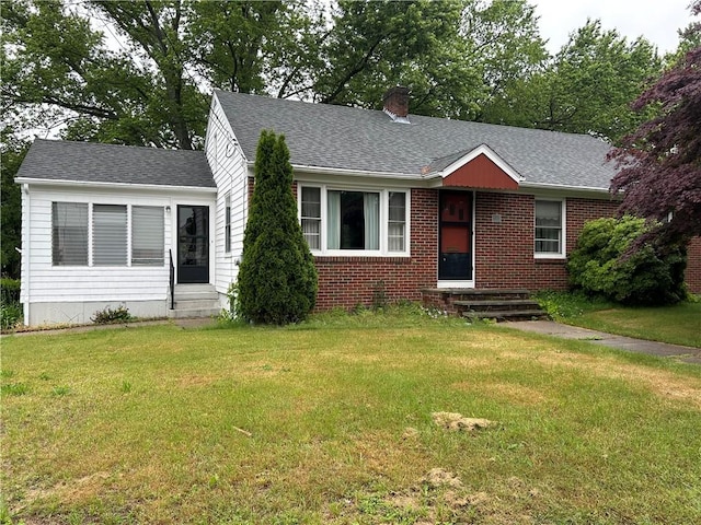 12 Oakland Ave, Johnston, RI 02919 - view of front facade with a front yard, a chimney, brick siding, and a shingled roof