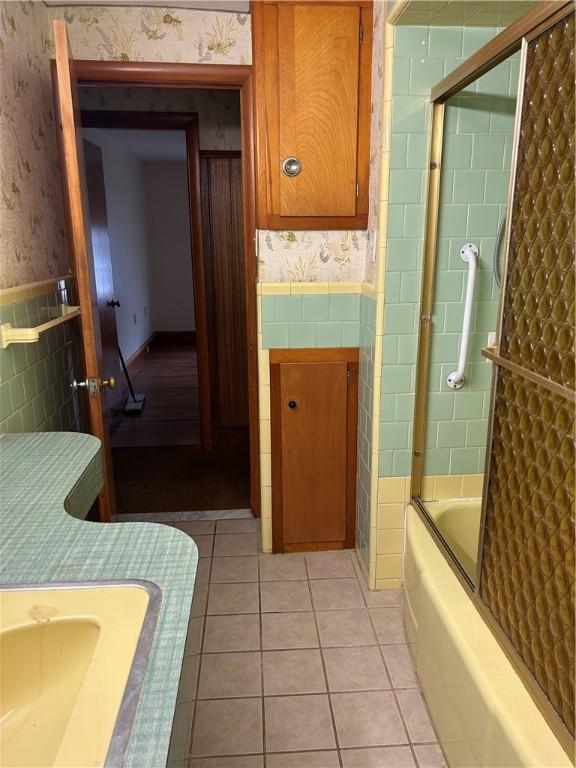 12 Oakland Ave, Johnston, RI 02919 - full bathroom with wallpapered walls, tile walls, a wainscoted wall, enclosed tub / shower combo, and tile patterned floors
