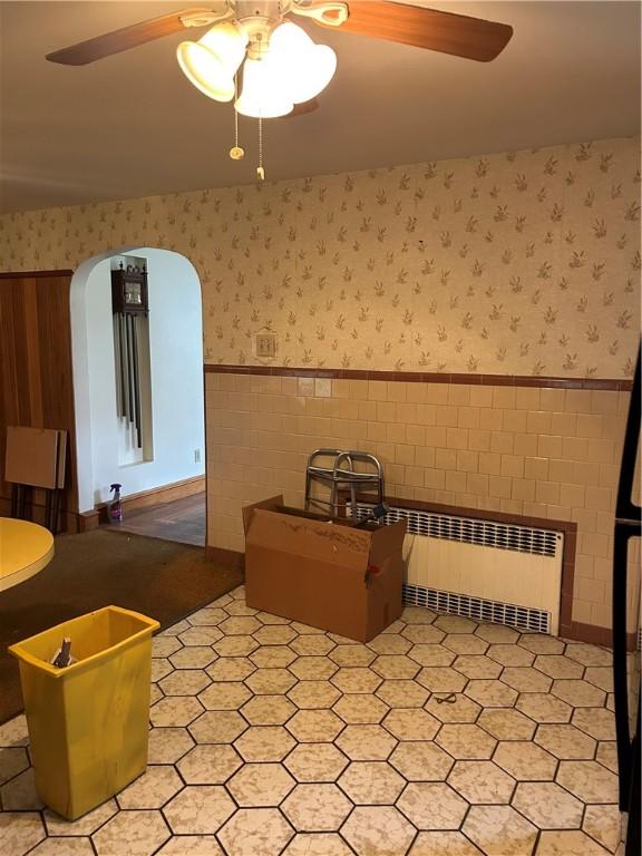 12 Oakland Ave, Johnston, RI 02919 - interior space featuring wallpapered walls, wainscoting, a ceiling fan, radiator, and tile patterned floors