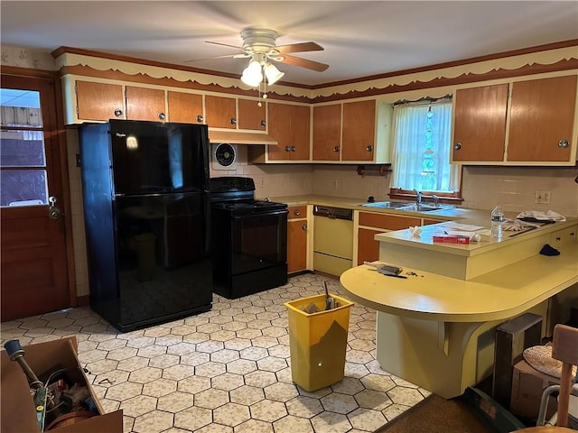 12 Oakland Ave, Johnston, RI 02919 - kitchen featuring black appliances, a peninsula, ceiling fan, light countertops, and brown cabinetry