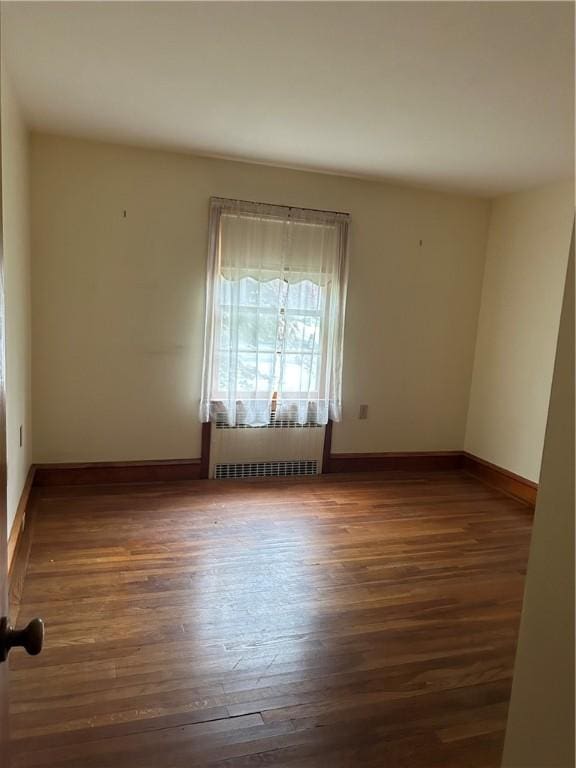 12 Oakland Ave, Johnston, RI 02919 - empty room featuring wood finished floors and radiator heating unit