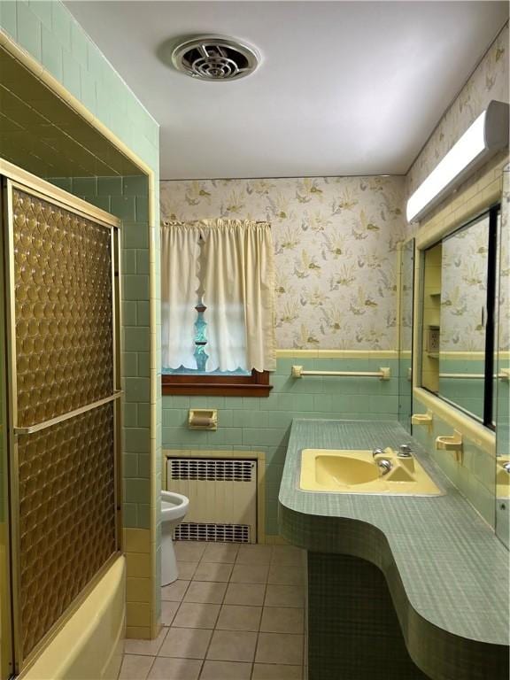 12 Oakland Ave, Johnston, RI 02919 - bathroom with radiator heating unit, tile patterned flooring, tile walls, wallpapered walls, and wainscoting