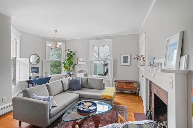 303 Angell St Unit 3, Providence, RI 02906 - living area with ornamental molding, a brick fireplace, wood finished floors, a chandelier, and a baseboard heating unit