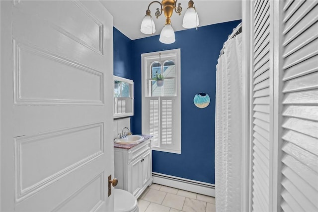 303 Angell St Unit 3, Providence, RI 02906 - bathroom with a baseboard heating unit, vanity, and tile patterned flooring