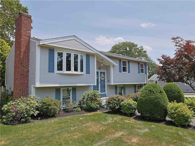184 Vallette St, Cranston, RI 02920 - bi-level home with a chimney and a front lawn