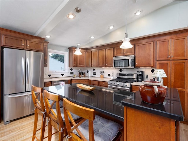 184 Vallette St, Cranston, RI 02920 - kitchen with appliances with stainless steel finishes, backsplash, light wood-style flooring, brown cabinets, and recessed lighting