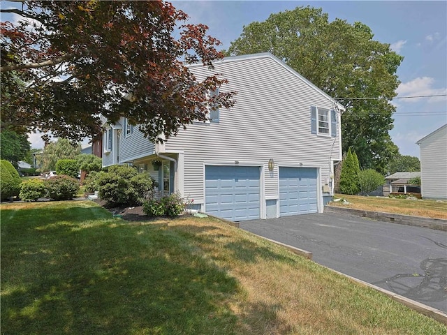 184 Vallette St, Cranston, RI 02920 - view of property exterior featuring a garage, asphalt driveway, and a yard