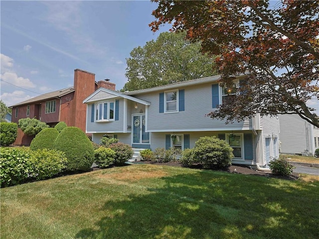 184 Vallette St, Cranston, RI 02920 - bi-level home featuring a front yard and a chimney