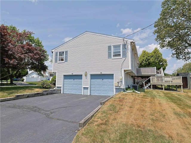 184 Vallette St, Cranston, RI 02920 - view of side of property featuring a garage, driveway, a lawn, a deck, and stairway