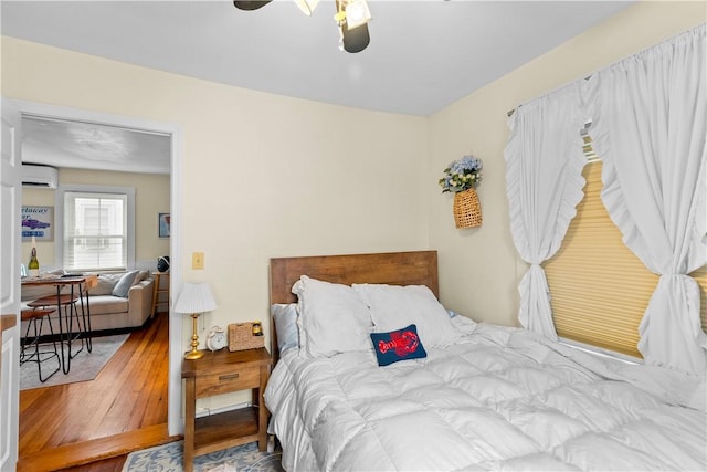 13 Dean Ave, Newport, RI 02840 - bedroom with a wall mounted AC, wood-type flooring, and ceiling fan