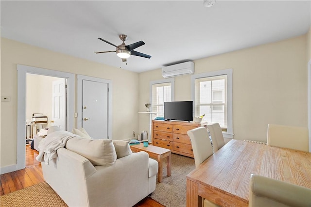 13 Dean Ave, Newport, RI 02840 - living area featuring a wall mounted AC, a ceiling fan, and wood finished floors