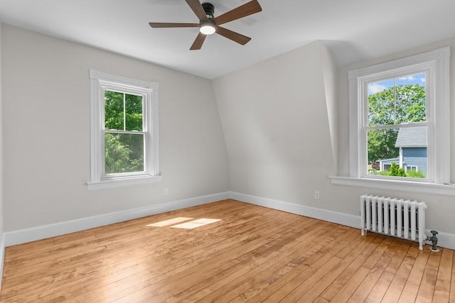11 Taft St, Coventry, RI 02816 - empty room with radiator, light wood-style flooring, and a ceiling fan