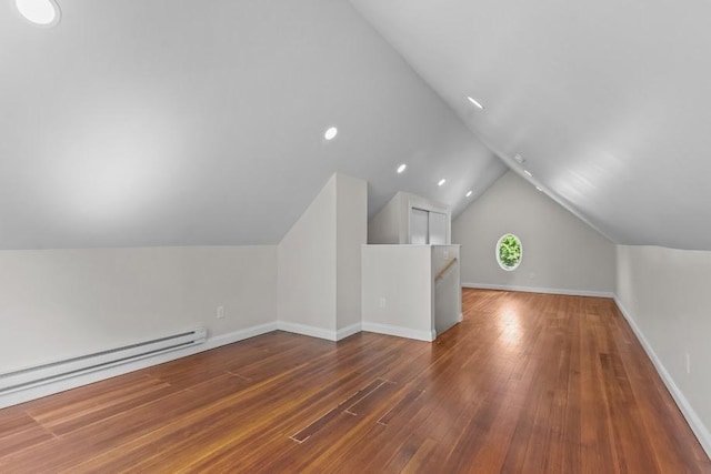 11 Taft St, Coventry, RI 02816 - additional living space with lofted ceiling, a baseboard heating unit, and wood-type flooring