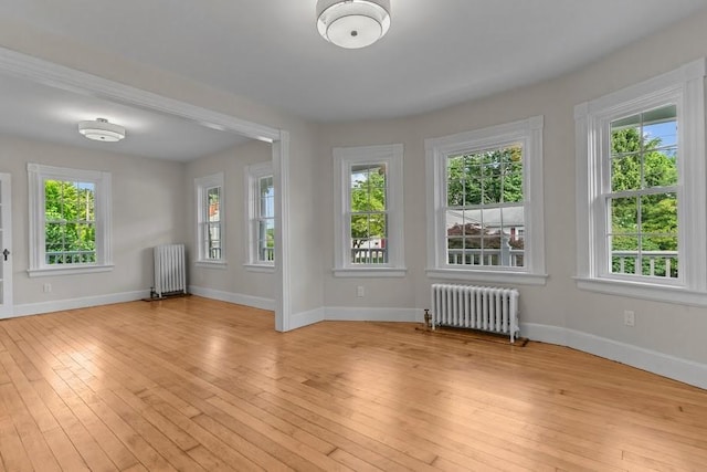11 Taft St, Coventry, RI 02816 - unfurnished room with radiator, plenty of natural light, and light wood-style flooring