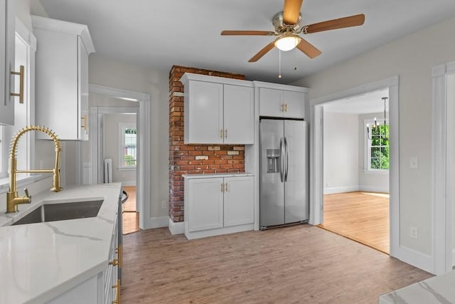 11 Taft St, Coventry, RI 02816 - kitchen with stainless steel refrigerator with ice dispenser, a ceiling fan, light wood-type flooring, and white cabinets