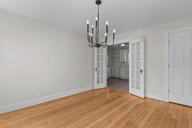 11 Taft St, Coventry, RI 02816 - unfurnished dining area with french doors, a chandelier, and light wood finished floors
