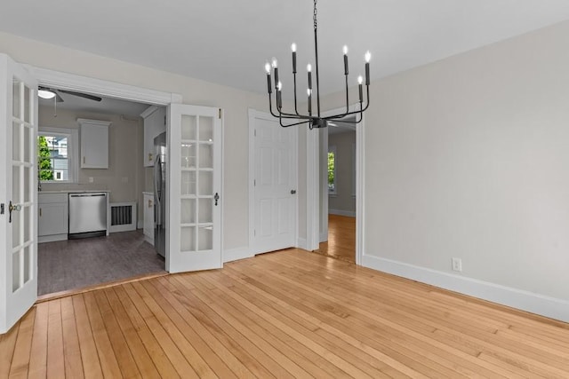11 Taft St, Coventry, RI 02816 - unfurnished dining area featuring french doors, a chandelier, light wood-type flooring, and ceiling fan