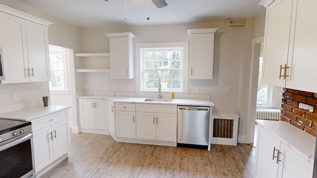 11 Taft St, Coventry, RI 02816 - kitchen with open shelves, stainless steel appliances, light wood-type flooring, and white cabinetry