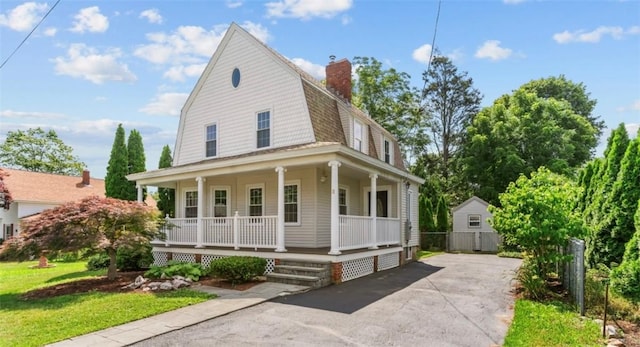 11 Taft St, Coventry, RI 02816 - view of front facade with a gambrel roof, covered porch, driveway, and a chimney