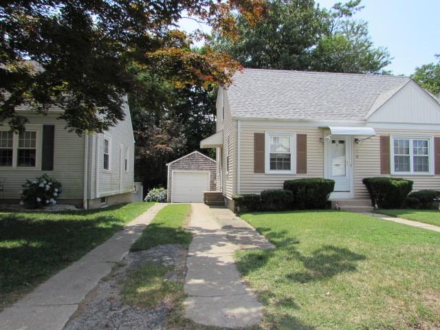 21 Hemlock Ave, Cranston, RI 02910 - view of front of home featuring an outdoor structure, a garage, driveway, a front yard, and roof with shingles