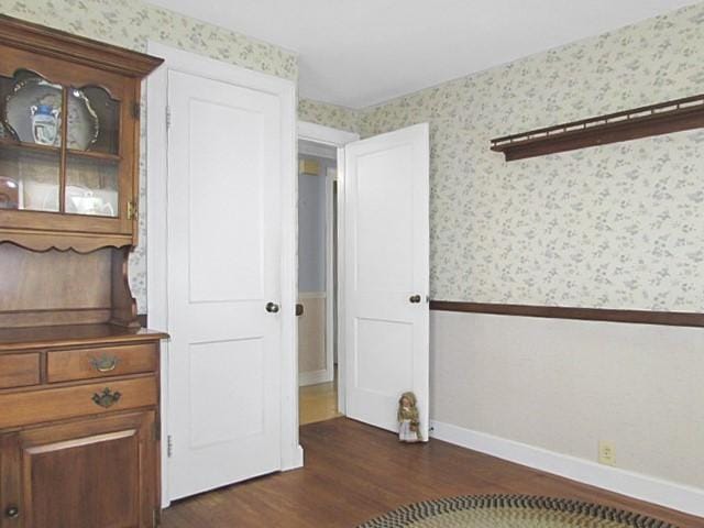 21 Hemlock Ave, Cranston, RI 02910 - unfurnished bedroom featuring wallpapered walls and dark wood-style floors
