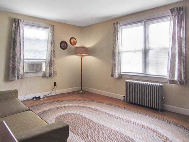 21 Hemlock Ave, Cranston, RI 02910 - unfurnished room with radiator heating unit, cooling unit, and wood finished floors