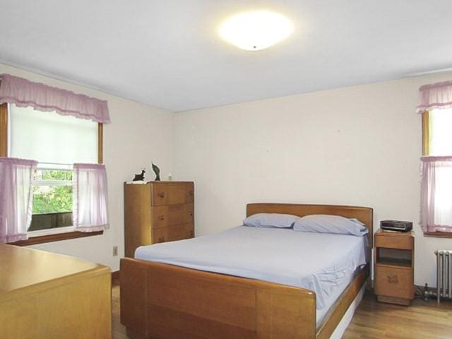 21 Hemlock Ave, Cranston, RI 02910 - bedroom with wood finished floors and radiator