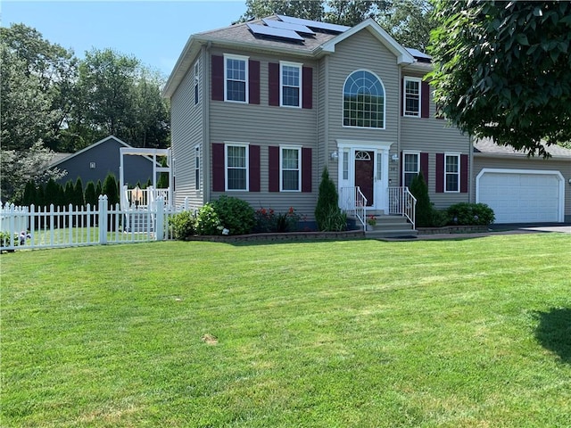50 Paliotta Pkwy, Cranston, RI 02921 - colonial house with roof mounted solar panels, a garage, and driveway