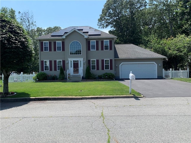 50 Paliotta Pkwy, Cranston, RI 02921 - colonial-style house with asphalt driveway, an attached garage, and solar panels