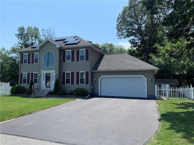 50 Paliotta Pkwy, Cranston, RI 02921 - colonial-style house with an attached garage, driveway, and roof mounted solar panels