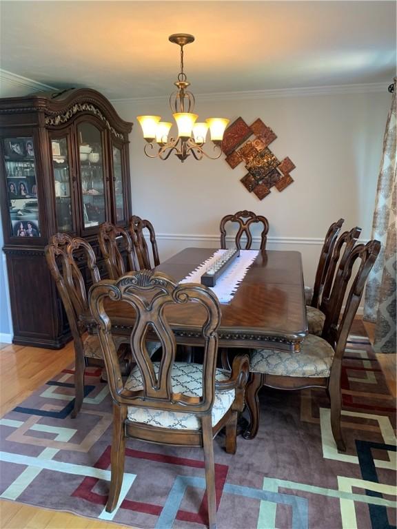 50 Paliotta Pkwy, Cranston, RI 02921 - dining space with a chandelier, ornamental molding, and light wood finished floors