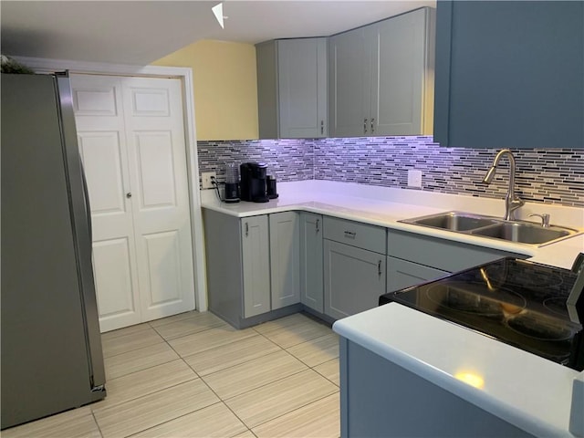 50 Paliotta Pkwy, Cranston, RI 02921 - kitchen with freestanding refrigerator, gray cabinetry, light tile patterned floors, and tasteful backsplash