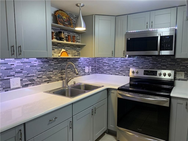 50 Paliotta Pkwy, Cranston, RI 02921 - kitchen featuring appliances with stainless steel finishes, light countertops, gray cabinets, backsplash, and pendant lighting
