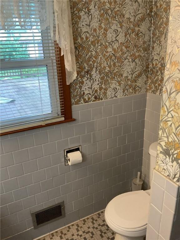 19 Leawood Dr, Cranston, RI 02920 - bathroom featuring wallpapered walls, wainscoting, plenty of natural light, and tile walls