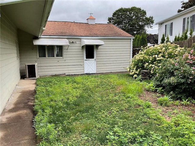 19 Leawood Dr, Cranston, RI 02920 - rear view of house with a shingled roof and a yard