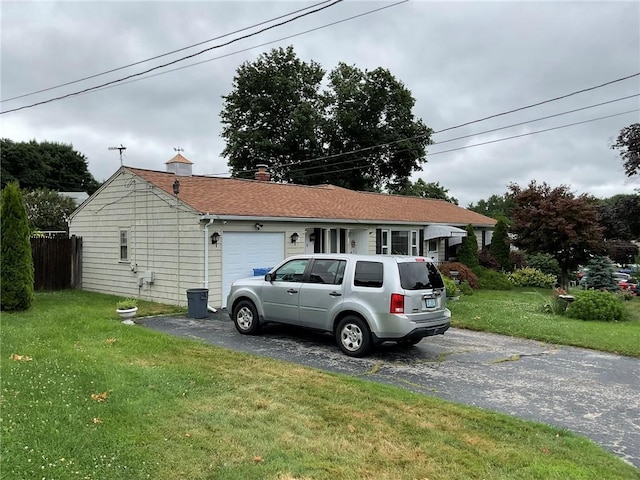19 Leawood Dr, Cranston, RI 02920 - view of front of home with driveway, an attached garage, a front lawn, and a chimney