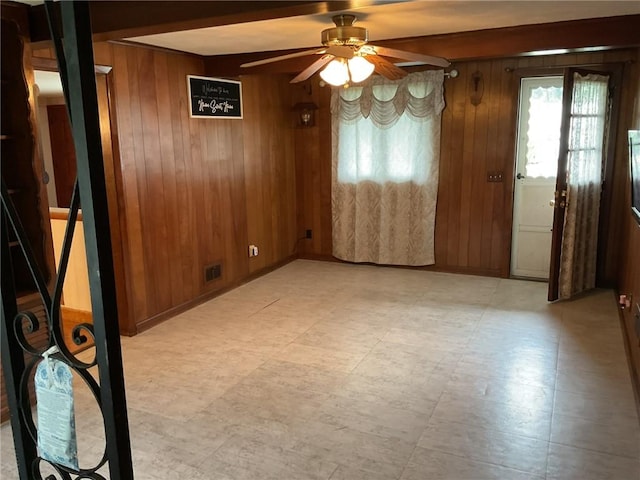 19 Leawood Dr, Cranston, RI 02920 - unfurnished dining area featuring wood walls, a ceiling fan, and beamed ceiling