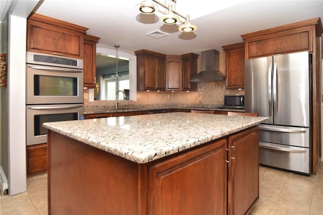 32 Harrington Dr, Johnston, RI 02919 - kitchen with appliances with stainless steel finishes, light tile patterned floors, a center island, and wall chimney exhaust hood