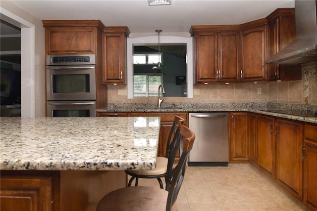 32 Harrington Dr, Johnston, RI 02919 - kitchen featuring wall chimney exhaust hood, stainless steel appliances, tasteful backsplash, and a breakfast bar area