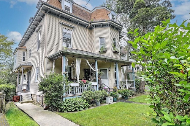 571 Spring St, Newport, RI 02840 - second empire-style home with a porch, a front yard, and mansard roof