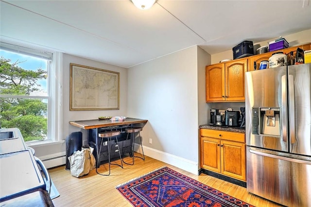 571 Spring St, Newport, RI 02840 - kitchen with stainless steel refrigerator with ice dispenser, light wood-style floors, healthy amount of natural light, and brown cabinetry