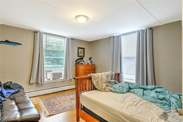 571 Spring St, Newport, RI 02840 - bedroom featuring baseboard heating, wood finished floors, and cooling unit