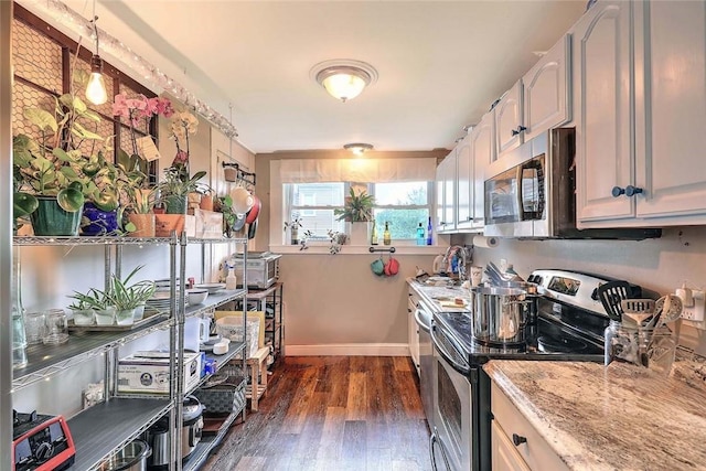 571 Spring St, Newport, RI 02840 - kitchen featuring appliances with stainless steel finishes, dark wood finished floors, and light stone countertops