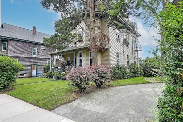 571 Spring St, Newport, RI 02840 - view of front of property with a front lawn, covered porch, and a chimney