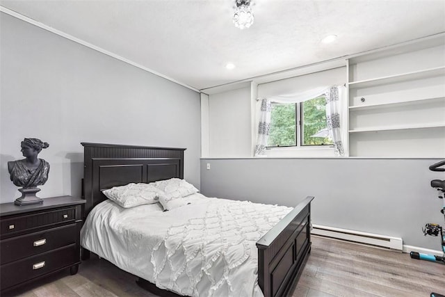 9 Ivy Hollow Ct, Cranston, RI 02921 - bedroom featuring baseboard heating, wood finished floors, and recessed lighting