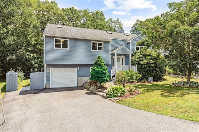 9 Ivy Hollow Ct, Cranston, RI 02921 - raised ranch featuring an attached garage, asphalt driveway, a front yard, a chimney, and a shingled roof