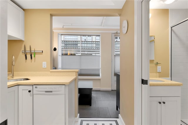 65 Weybosset St Unit 222, Providence, RI 02903 - kitchen with dishwasher, dark colored carpet, white cabinets, and light countertops