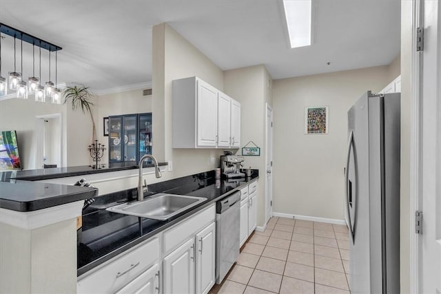 1000 Providence Pl Unit 201, Providence, RI 02903 - kitchen with dark countertops, freestanding refrigerator, white cabinetry, stainless steel dishwasher, and light tile patterned floors
